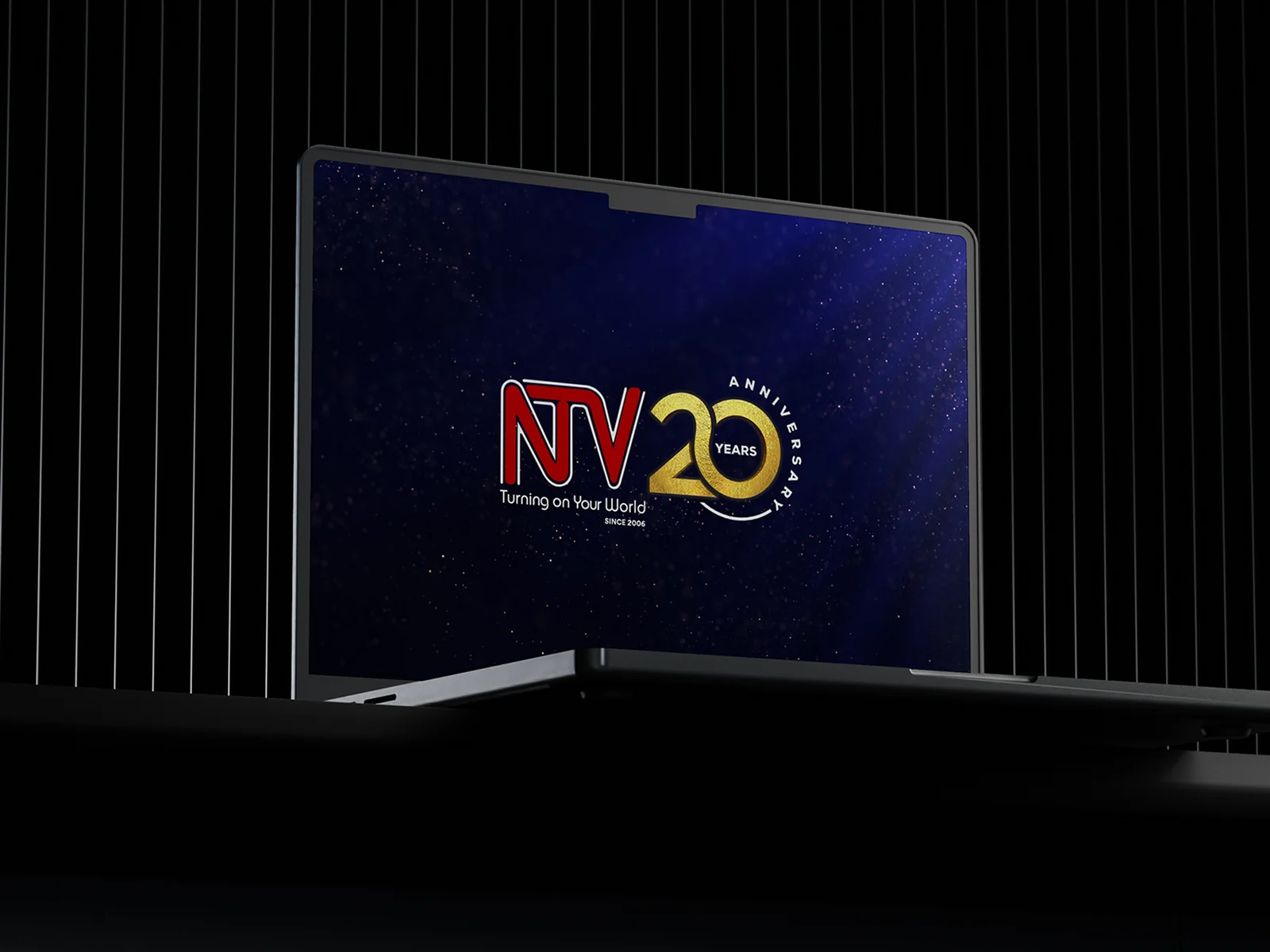NTV 20 anniversary identity in navy and gold, applied to insulated tumblers, a polo shirt, a keyring and a television screen